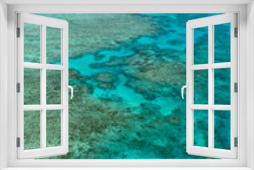 Fototapeta Naklejka Na Ścianę Okno 3D - Great Barrier Reef Blue Ocean Sea view. Beautiful aqua & turquoise waters, with coral reef patterns in the ocean. View from helicopter, on vacation. Marine life, global warming, protection, island