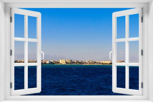 Fototapeta Naklejka Na Ścianę Okno 3D - Beautiful view of the coastline with houses and hotels in Hurghada, Egypt. View from Red sea