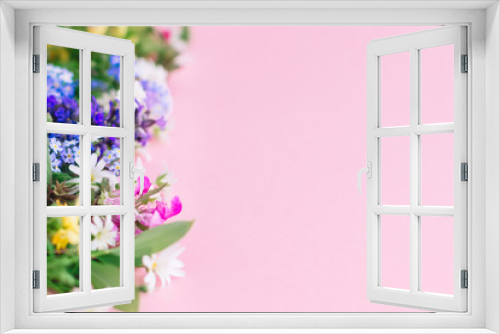 Fototapeta Naklejka Na Ścianę Okno 3D - Colorful spring wildflowers border on pink paper background, space for text. Floral greeting card template. Happy Mother's day concept. Hello spring. Blooming spring flowers