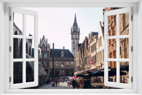 Fototapeta Naklejka Na Ścianę Okno 3D - GHENT, BELGIUM - August, 2019: Facade of Saint Nicholas' Church (Sint-Niklaaskerk) with the clock tower of Belfry of Ghent (Het Belfort) at the background, in Ghent. Before before corona crisis