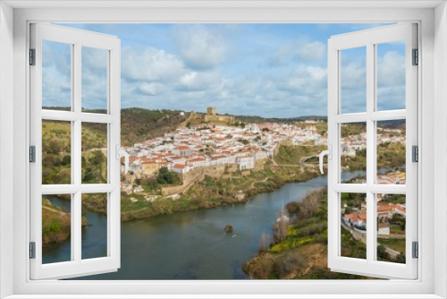 Aerial view of the city of Mértola. Historic center of Mértola, castle, church, and Guadiana river, Alentejo, Portugal