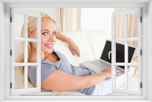 Blonde woman switching on her laptop