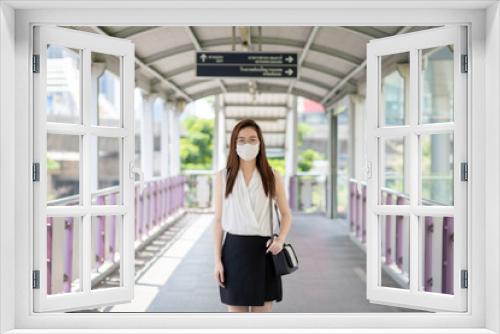 COVID-19 Pandemic Coronavirus Asian Woman in city street going to work. She wearing face mask protective for spreading of disease virus. 