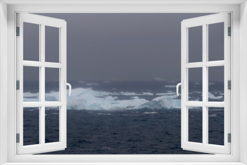 Fototapeta Naklejka Na Ścianę Okno 3D - Icebergs in antarctic sea during storm, with dark ocean, Antarctica