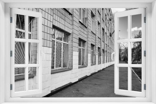 Fototapeta Naklejka Na Ścianę Okno 3D - Multi-storey building school with bars on the windows to protect against bullies.