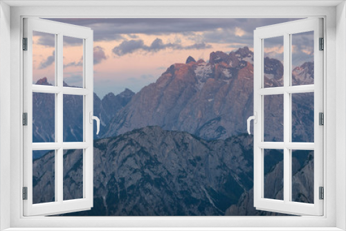 Fototapeta Naklejka Na Ścianę Okno 3D - Mountain landscape in the European Dolomite Alps underneath the Three Peaks with alpenglow during sunset, coloured clouds in the sky, South Tyrol Italy.