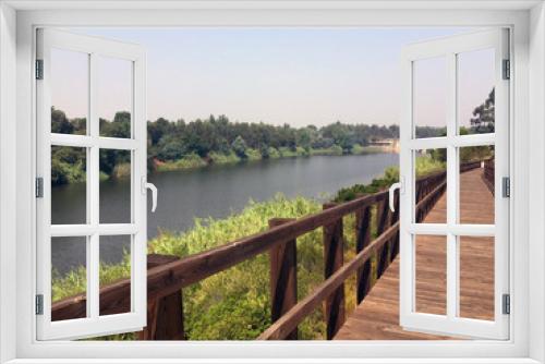 Fototapeta Naklejka Na Ścianę Okno 3D - wooden footbridge in perspective on the river bank