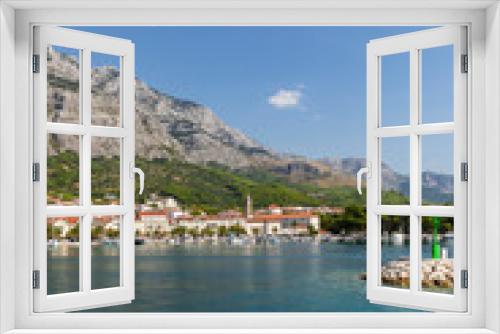 Fototapeta Naklejka Na Ścianę Okno 3D - Makarska in Dalmatia, Croatia. View from the sea on a sunny day in the summer and a blue sky. A famous place with beaches and the Biokovo mountain. Holiday at the Mediterranean coast vertical