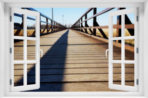 Fototapeta Naklejka Na Ścianę Okno 3D - Empty new wooden bridge with fence shadow