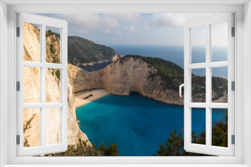 Fototapeta Naklejka Na Ścianę Okno 3D - Idyllic view of the beautiful Navagio beach on the island of Zakynthos in Greece. the cliffs are of white rock, the water of the sea a deep blue and the beach of white sand