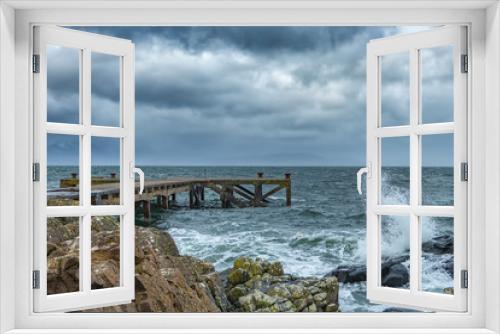 Fototapeta Naklejka Na Ścianę Okno 3D - A stormy Portencross harbour and Jetty on the West Coast of Scotland.