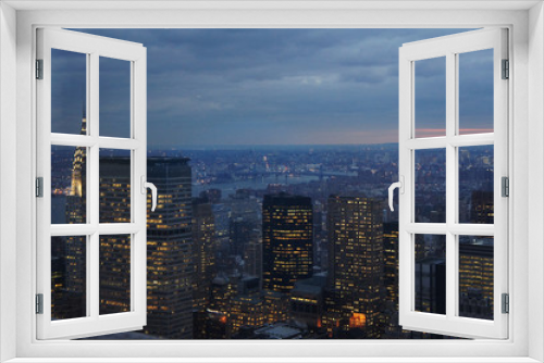 Fototapeta Naklejka Na Ścianę Okno 3D - New york city lights of business offices in Manhattan at dusk or dawn. Urban cityscape at twilight. Concept of overpopulated megapolis. USA/America. Home office concept during coronavirus.  