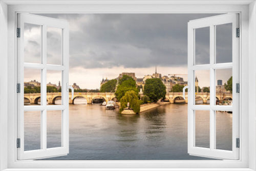 Fototapeta Naklejka Na Ścianę Okno 3D - Paris, France - May 10, 2020: 'Pont Neuf', the oldest bridge in Paris with the 'ile de la cité' in the middle of the photo on a stormy day
