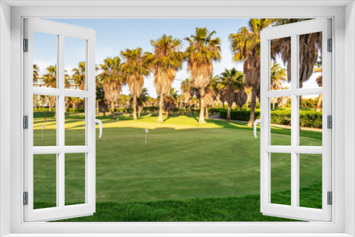 Fototapeta Naklejka Na Ścianę Okno 3D - Beautiful golf course with green grass. Tall trees. Sunny day with a blue, clear sky. Portugal, Algarve.