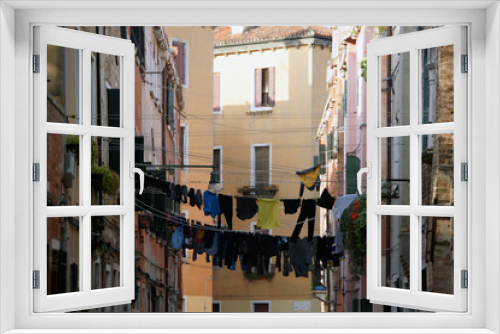 Fototapeta Naklejka Na Ścianę Okno 3D - Photo of the street in Venice with loundry on the rope. Castello district.