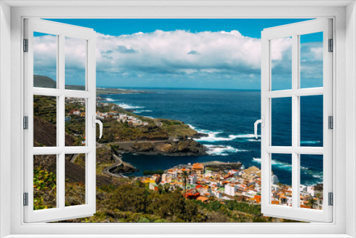 Fototapeta Naklejka Na Ścianę Okno 3D - Panorama of the city of Garachico from above on the background of the ocean. The island of Tenerife in the spring on a Sunny day. A town on a tropical island in Spain