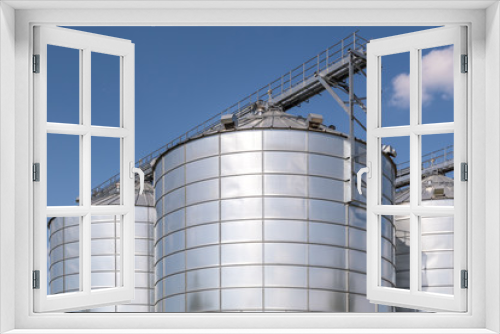 Fototapeta Naklejka Na Ścianę Okno 3D - agro-processing and manufacturing plant for processing and silver silos for drying cleaning and storage of agricultural products, flour, cereals and grain. Granary elevator.