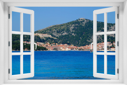 Fototapeta Naklejka Na Ścianę Okno 3D - Hvar island from the distance - View of the old port and the Spanish fortress of Hvar city from a boat in the Adriatic Sea