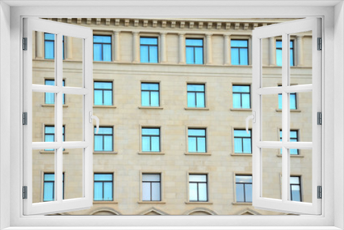 Fototapeta Naklejka Na Ścianę Okno 3D - Symmetrical Windows on a Building Facade in Barcelona, Spain