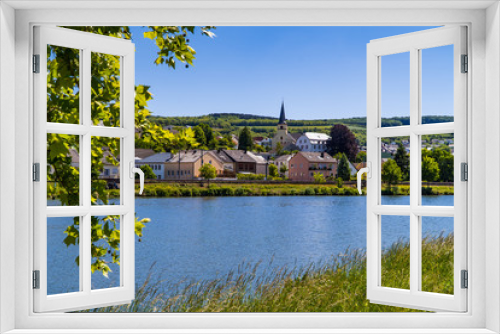 Fototapeta Naklejka Na Ścianę Okno 3D - The Beautiful town of Nittel in Germany with church tower on the Moselle river