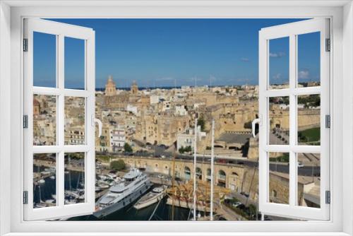 Fototapeta Naklejka Na Ścianę Okno 3D - Aerial view of sailboats moored in harbour Senglea and Birgu, Bormla / Cospicua, Valletta, Malta. Ancient architecture of old town: christian orthodox churches, cathedrals, basilicas. Sunny day, blue 