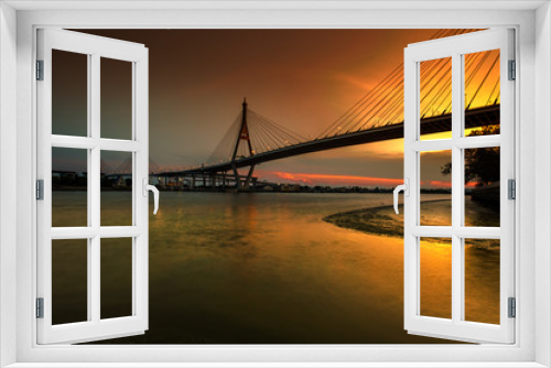 Fototapeta Naklejka Na Ścianę Okno 3D - The blurred background of the twilight evening by the river, the natural color changes, the bridge over the river (Bhumibol Bridge) is one of the major transportation bridges in Bangkok, Thailand