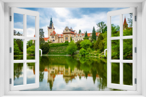 Castle with reflection in pond in spring time in Pruhonice, Czech Republic