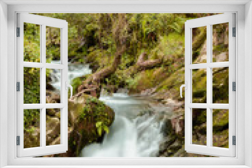 Fototapeta Naklejka Na Ścianę Okno 3D - Waterfall in surrounded by tress and rocks in a forest in Galicia