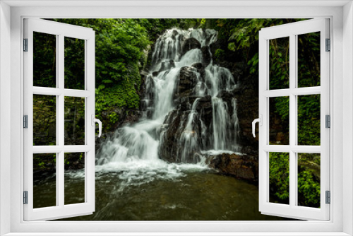 Fototapeta Naklejka Na Ścianę Okno 3D - Waterfall landscape. Beautiful hidden Jembong waterfall in tropical rainforest in Ambengan, Bali. Slow shutter speed, motion photography.