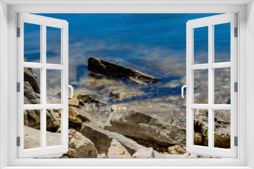Fototapeta Naklejka Na Ścianę Okno 3D - Long Exposure of Large Rocks in a Lake
