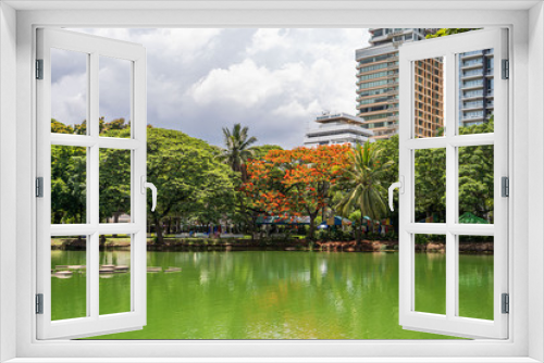 Fototapeta Naklejka Na Ścianę Okno 3D - Bautiful view of lake and modern buildings in Lumpini Park, Bangkok, Thailand