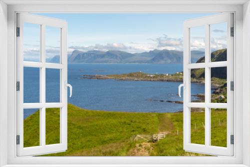 Fototapeta Naklejka Na Ścianę Okno 3D - View from Runde bird island in Alesund, Norway towards little fishing village, the ocean and the mountains in the background.