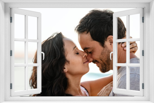 Loving couple standing with their eyes closed on a beach