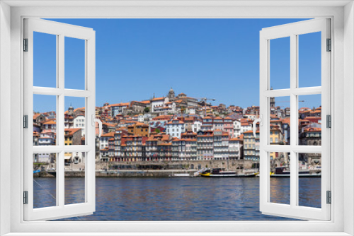 Colorful houses of Porto Ribeira, traditional facades, old multi-colored houses with red roof tiles on the embankment in the city of Porto, Portugal. Unesco World Heritage.