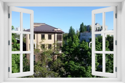 Fototapeta Naklejka Na Ścianę Okno 3D - View from the balcony of a multi-storey building on the city houses