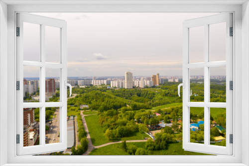 Fototapeta Naklejka Na Ścianę Okno 3D - panoramic views of a big city with houses and roads filmed from a drone