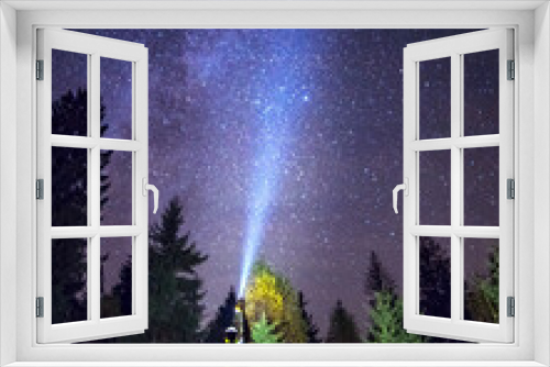 Fototapeta Naklejka Na Ścianę Okno 3D - Silhouette of climber standing against the Milky Way with a flashlight in his hands. Location Carpathian, Ukraine, Europe. Astrophotography of milkyway. Dramatic scene. Discover the beauty of earth.