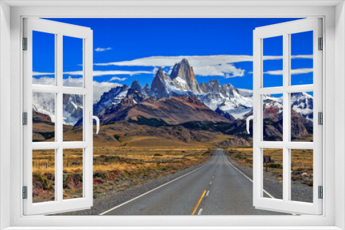 Fototapeta Naklejka Na Ścianę Okno 3D - Fitz Roy and Torre mountains with route and cars at foreground, during a sunny day with clouds.