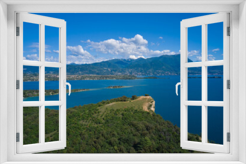 Fototapeta Naklejka Na Ścianę Okno 3D - Lake Garda, Italy. Aerial view of punta sasso, rocca di manerba in the background mountains, san biagio island, garda island at high altitude