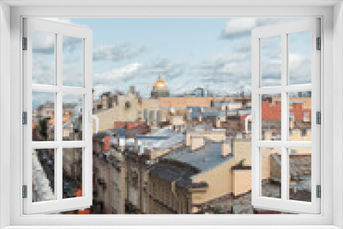 Fototapeta Naklejka Na Ścianę Okno 3D - Sunset view at the Isaak Cathedral from the roof of Saint-Petersburg city. Ancient roof of the city. Old historical city. Amazing sunset at the top of the city