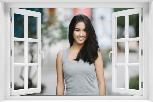 Summer sunny lifestyle fashion portrait of young stylish hipster Asia woman walking on the street, wearing cute trendy outfit