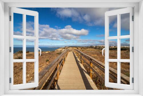 Fototapeta Naklejka Na Ścianę Okno 3D - Wooden Boardwalk Leading to the Blue Sky
