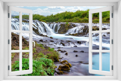 Fototapeta Naklejka Na Ścianę Okno 3D - Bruarfoss Waterfall in the summer, with trees and green grass all over the area. This is a waterfall that is hidden among nature in Iceland.