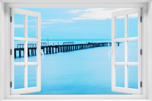 Fototapeta Naklejka Na Ścianę Okno 3D - Long exposure view of wooden bridge in blue background