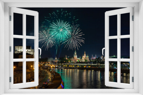 Fototapeta Naklejka Na Ścianę Okno 3D - Green and white color circles of May 9 fireworks in dark night sky over Moscow cityscape with the Kremlin towers, reflection in the river, Saint Basil's Cathedral and floating bridge