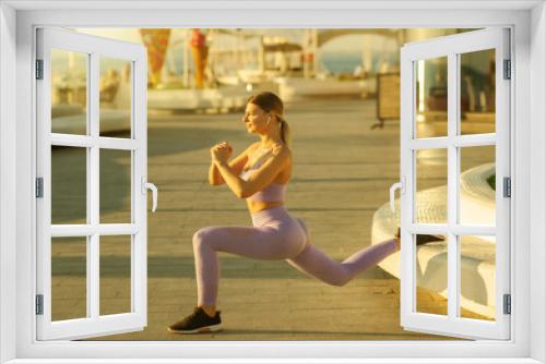 Morning workout concept. Young fit woman in sportswear doing lunges exercise at sunrise outdoors