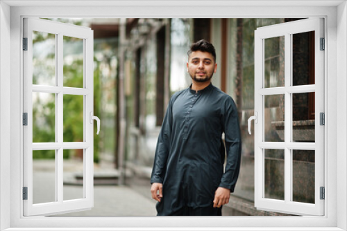 Сonfident pakistani indian muslim arabic boy in grey kameez shalwar suit.