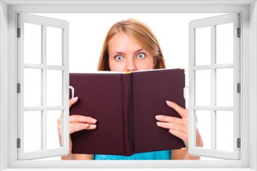 Portrait of young woman amazed by what she is reading