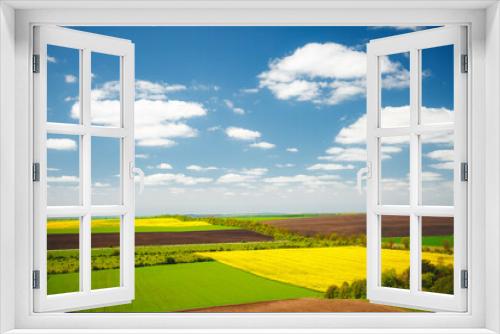 Fototapeta Naklejka Na Ścianę Okno 3D - Picturesque rural area on the springtime and fluffy white clouds on a sunny day.