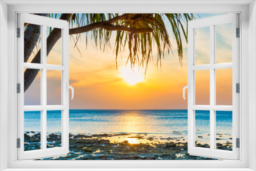 Fototapeta Naklejka Na Ścianę Okno 3D - Sunset sea and beach with coconut palm tree and sunset sun on dramatic sky